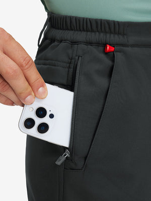 Close-up detail showing phone being placed in the pocket of grey thermal water repellent fleece dress pants