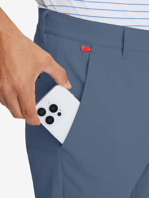 Side pocket detail of Golf Lightweight Fleece Lined Dress Pants in advanced grey, holding smartphone