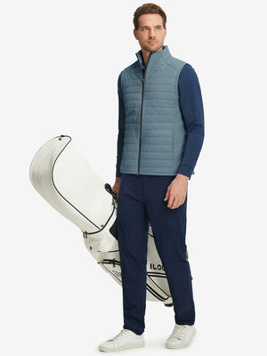 Model wearing Lightweight Water Resistant Puffer Vest in slate blue, holding golf club