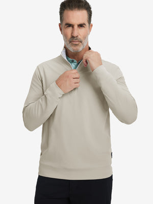 Front upper body view of model wearing lightweight golf quarter zip pullover in khaki light, relaxed fit.