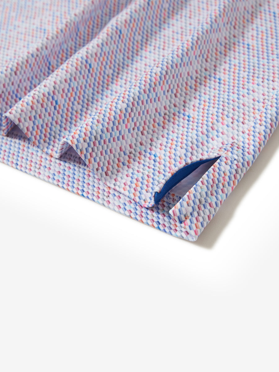 Hem slit detail of the colourful hexagon lightweight print long sleeve polo, showing fine stitching and finish.