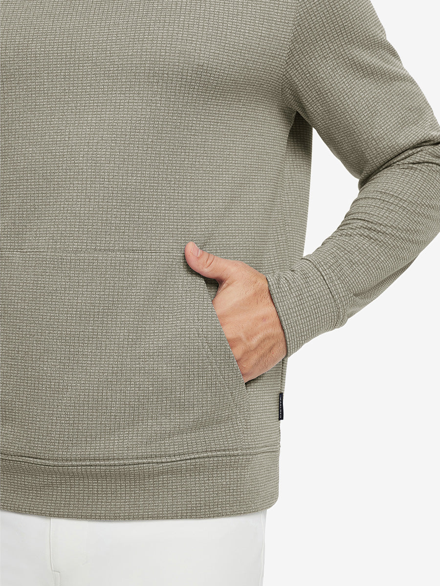 Close-up of model with both hands in pockets wearing warm fleece golf hoodies pullover  dust beige.