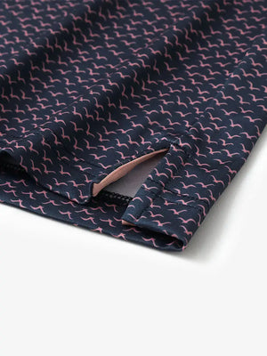 Detailed close-up of side hem slit on NAVY PINK SEAGULL Performance Print Boys Golf Polo for comfort