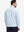 Back upper body angle of the sky blue camo full print quarter zip pullover, model turns head slightly.