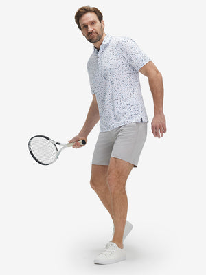 Full-body front view of model wearing the blue navy dot 4 way stretch print collared polo shirt, showing the complete outfit