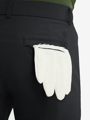 Close-up of the back pocket detail on the black stretch soft flat front dress golf shorts, emphasizing storage
