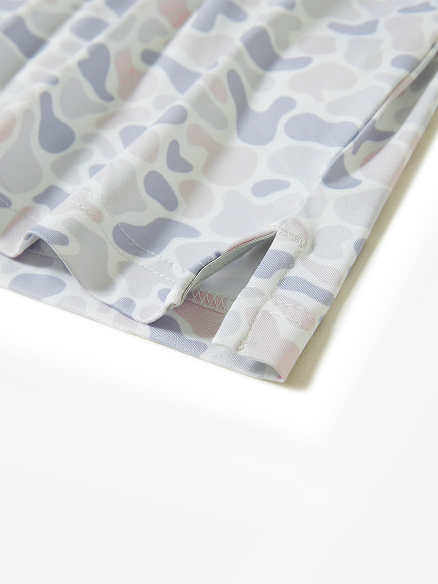 Hem slit detail of the brown & gray camo lightweight print long sleeve polo, showing fine stitching and finish.