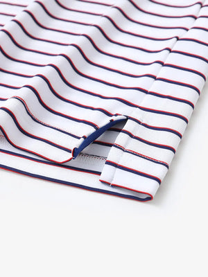 Hem slit detail of WHITE/NAVY STRIPE Youth Performance Golf Polo highlighting stitching and finish.