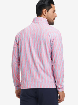 Back upper body angle of the pink small fish full print quarter zip pullover, model turns head slightly.