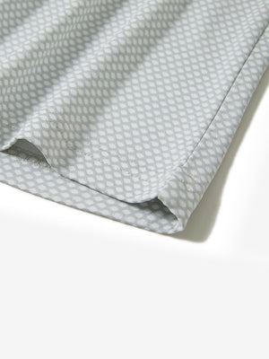 Hem detail of jacquard quarter zip pullover in light grey, focusing on stitching and side vent finish.