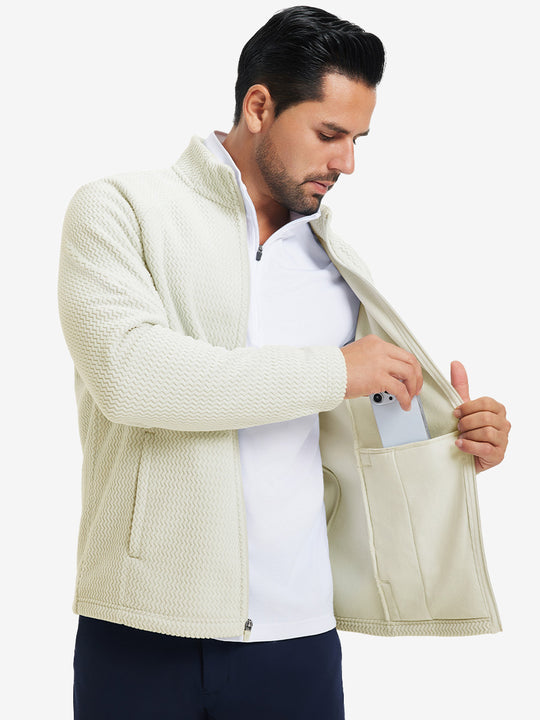 Model showing inner pocket of soft winter fleece jackets in beige, fitting an iPhone inside.