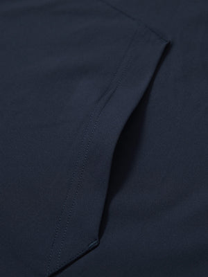 Close-up of single pocket detail on youth long sleeve hoodied with kangaroo pocket in navy, showing stitching.