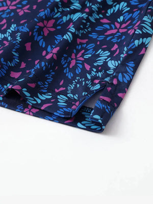 Detailed close-up of side hem slit on NAVY COLORFUL FLOWER Performance Print Boys Golf Polo for comfort