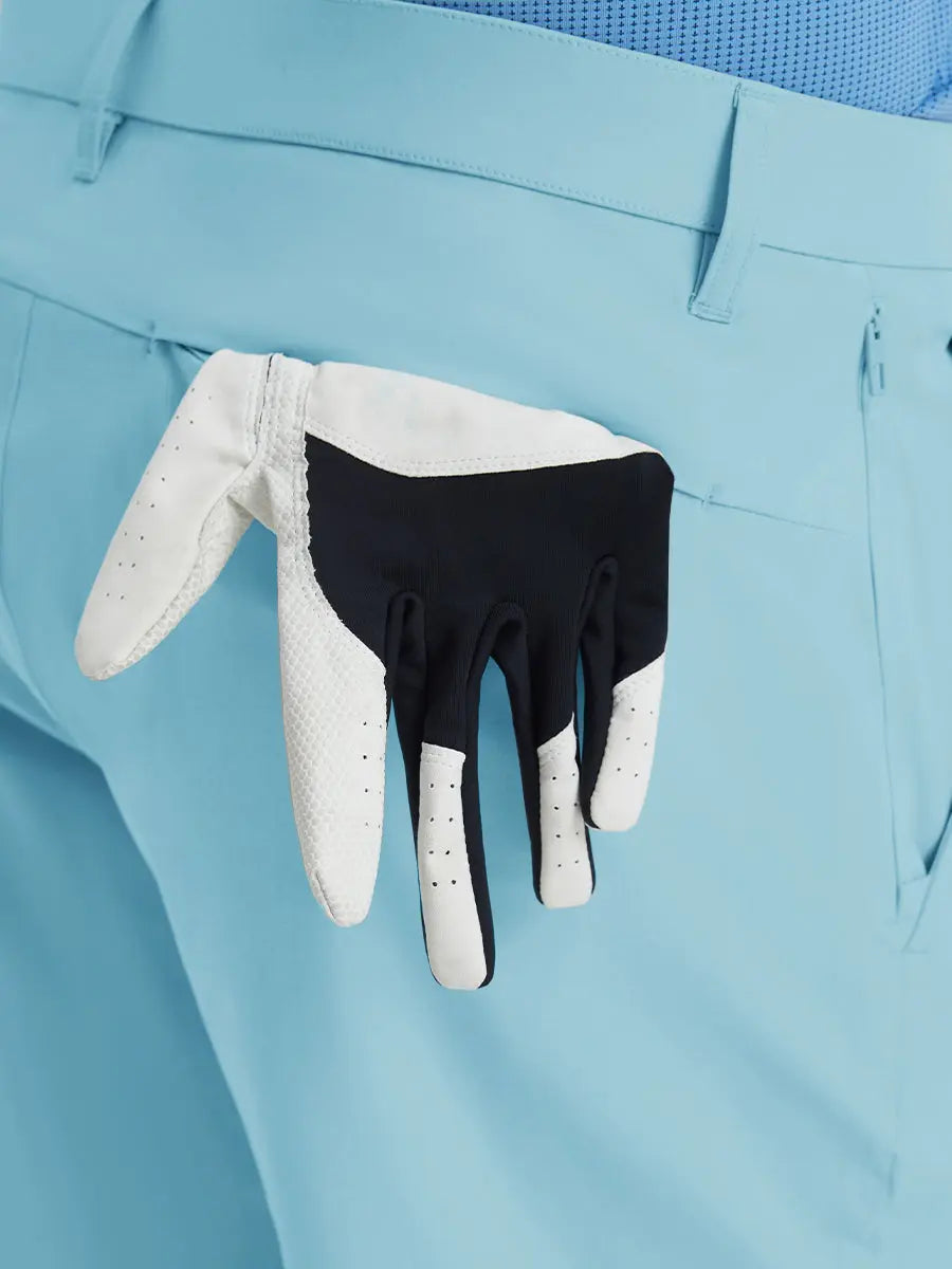 Back view of Player Fit Versatile Solid Shorts 9 Inch with golf glove tucked into right pocket – LIGHT BLUE