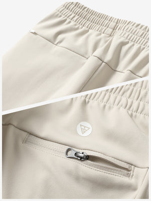 Close-up of the zipper detail of light khaki fleece stretch water resistant boys joggers.