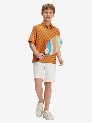 Full front: boy in orange cactus performance print boys golf polo holding sports gear.