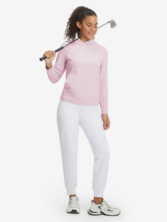 Model holding golf club, dressed in women's lightweight hoodies pullover in pale pink.