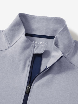 Close-up collar detail of navy two tone pique cotton blend q-zip with subtle logo