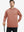 Model with one hand in pocket, wearing classic heather pullover hoodie in brick melange, relaxed look.