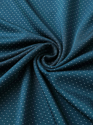 Close-up of lyons blue 4 way stretch jacquard polo fabric texture highlighting intricate woven pattern and elasticity.