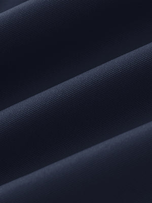 Fabric close-up of Women's 7/8 ankle golf track pants with soft texture in navy