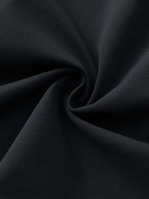Close-up of black stretch plain everyday pants fabric showing smooth texture and flexible weave.
