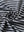 Close-up of black stripe sport fit stripe polo fabric showing crisp horizontal stripes and smooth, breathable texture.