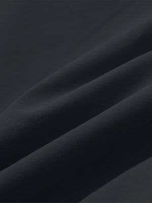 Close-up of black boys lightweight dry fit flat front golf shorts fabric texture.