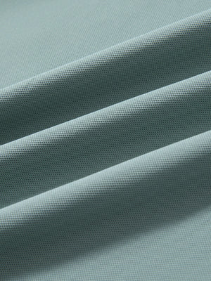 Fabric detail of Long sleeve performance solid pique polo with breathable knit in beryl green