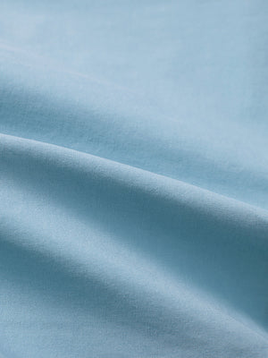 Close-up texture of sky blue flat front flex cotton blend golf shorts fabric showing detailed cotton blend material and weave.