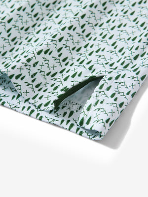 Close-up of the hem vent on the green forest 4 way stretch print collared polo shirt, showing the side split for movement