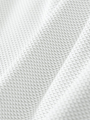 Close-up of the textured jacquard fabric on the grey white feather weight jacquard polo shirts