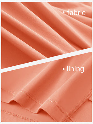 Close-up texture of peach pink women's moisture-wicking athletic tennis skirts fabric showing detailed outer and inner lining material.