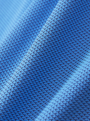Close-up of the textured jacquard fabric on the plum blue feather weight jacquard polo shirts