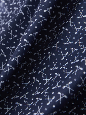 Macro view of the dark blue golf club 4 way stretch print collared polo shirt fabric, showcasing the unique print design