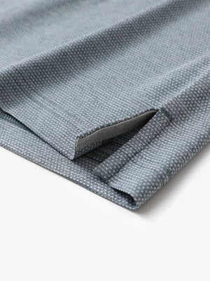 Hem slit detail close-up on SLATE GREEN HEATHER Ventilated Heather Jacquard Polo
