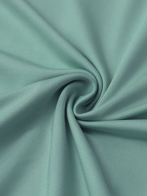 Close-up of beryl green everyday solid jersey polo fabric showing soft knit texture and smooth surface.