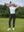 Woman wearing Women's Ultra-stretch Quick Dry Sweatpants with Ankle Zips in black, holding golf club on course