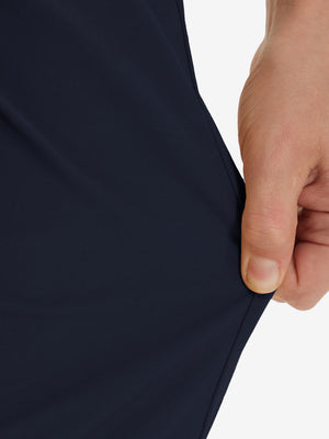 Action shot demonstrating the stretch of the navy youth water resistant cotton blend golf pants for active movement