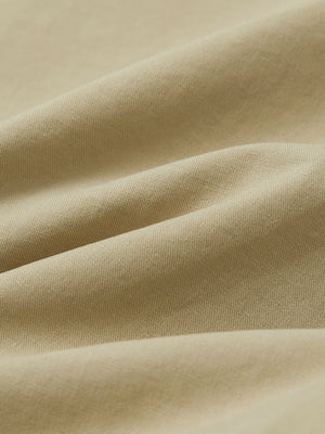 Macro view of the khaki youth water resistant cotton blend golf pants fabric, showcasing the water repellent surface