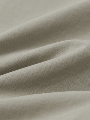 Macro view of the khaki grey youth water resistant cotton blend golf pants fabric, showcasing the water repellent surface