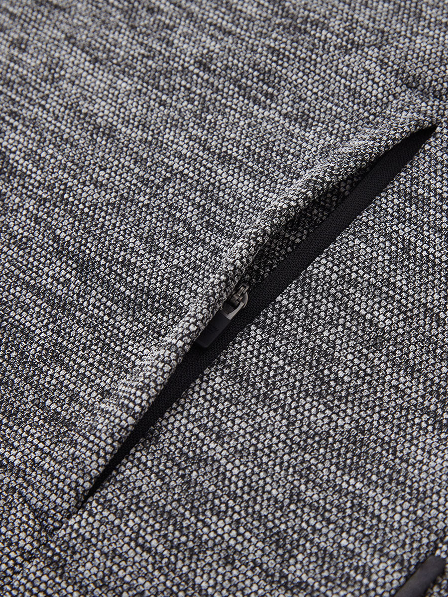 Close-up of jacket pocket showing fine stitching and insulation detail, textured insulated winter jacket, black heather.