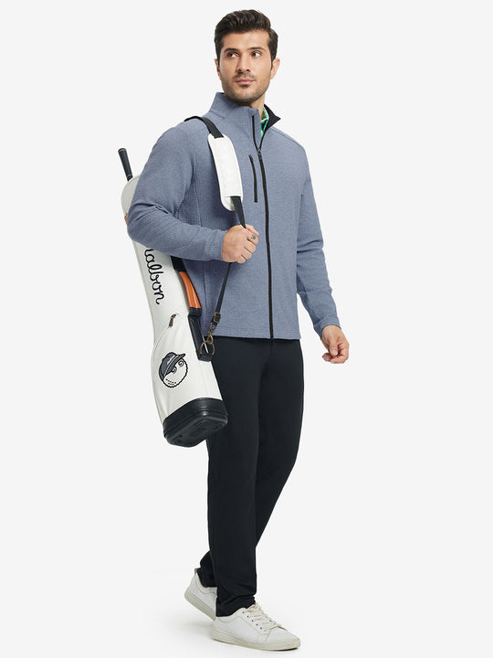 Full body shot, model carrying golf bag in textured insulated winter jacket, active outdoor style, blue heather.