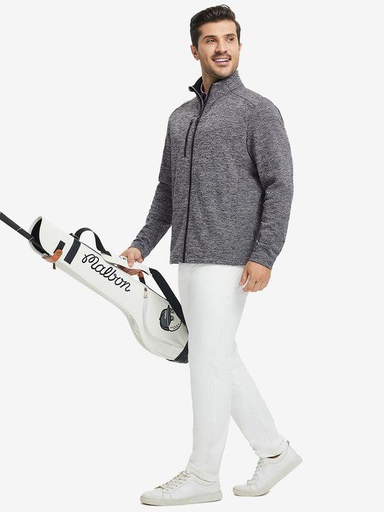 Full body shot, model carrying golf bag in textured insulated winter jacket, active outdoor style, black heather.