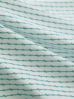 Close-up of light green lines lightweight stretch upgraded print golf polo shirts, showcasing texture and print details.